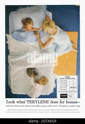 A 1960s advert for man-made fabrics Terylene and Crimplene in the home. The advert appeared in a magazine published in the UK in October 1962. The photograph shows a mother and two young children with the fabrics used in bedding and rugs. The textiles were popular in the 1960s and 70s but better man-made fibres and natural fibres later became more popular. Terylene (or Dracon) is a synthetic polyester fibre with patent rights owned by chemical company ICI. Crimplene is a texturised fibre produced by modifying Terylene. ICI licensed the product to various companies – vintage 1960s graphics. Stock Photo