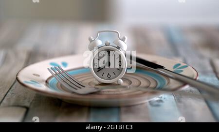 Close Up View Of Alarm Clock On A Plate Intermittent Fasting Diet Concept , Time To Eat Healthy