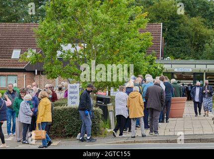 Long orderly queue (of people aged 65+) for the 'flu jab at Lakeside surgery, Corby, England. Stock Photo