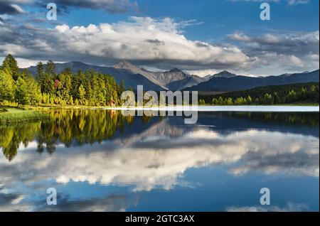 Beautiful mountain lake in Altai mountains with reflection at sunset Stock Photo