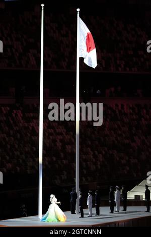 JULY 23rd, 2021 - TOKYO, JAPAN: MISIA sings the National Anthem of Japan while the flag was raised up by the members of the Japan Self-Defense Forces Stock Photo