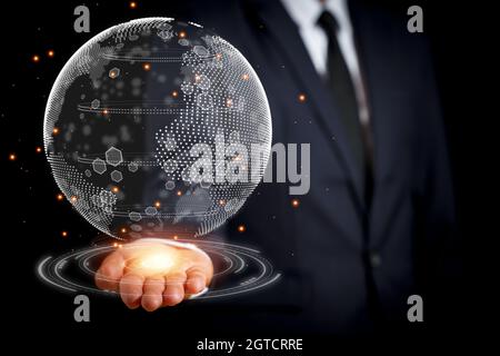 The businessman reached out with a 3D globe in his hand. concept to the search for clean energy to reduce the generation of energy that destroys the w Stock Photo