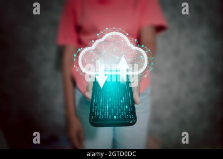 Woman holding a telephone with a cloud icon, symbol of personal data collection backup on the internet. the concept of cyber information data and priv Stock Photo