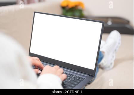 Over shoulder closeup view of female businesswoman looking at empty blank mockup screen for advertising, having virtual videoconference. Remote e lear Stock Photo