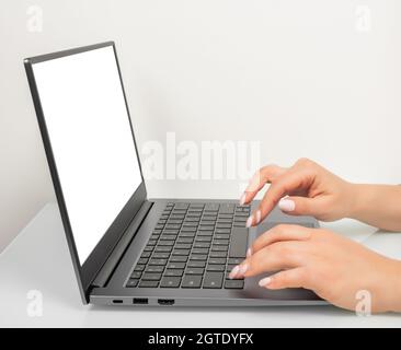 Business woman hands using mockup laptop with white blank screen. side view. hand woman work using laptop with white background for advertising,contac Stock Photo