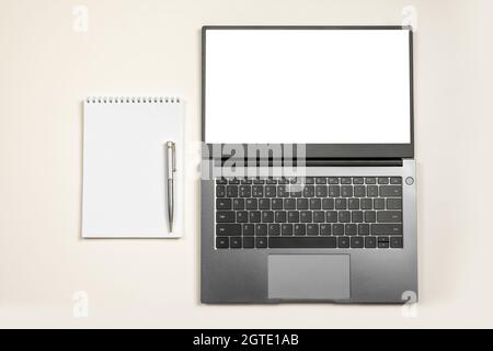 Minimal workplace mockup with laptop and blank notepad on white isolated background. laptop with blank screen or mock up computer for apply screen dis Stock Photo