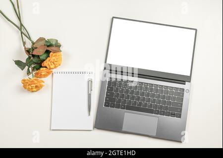 Minimal workplace mockup with laptop and blank notepad on white table. top view. mockup laptop, coffee, notebook and notepad on office desk, Top view Stock Photo