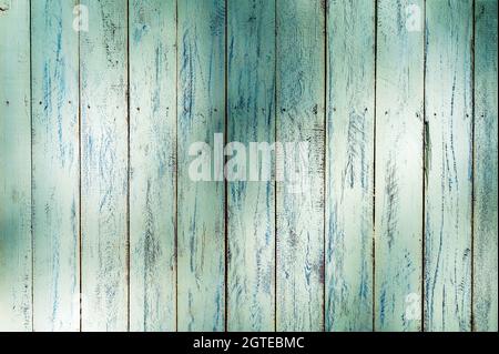 Weathered green wooden wall in partial shade Stock Photo