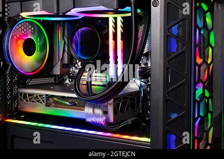 Inside view of black high end custom colorful illuminated bright rainbow RGB LED gaming pc. Computer power hardware and technology concept background Stock Photo