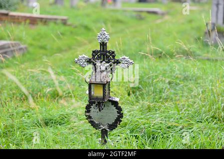 Vienna, Austria. The Vienna Central Cemetery. Metal cross with Jesus figure at the central cemetery Stock Photo