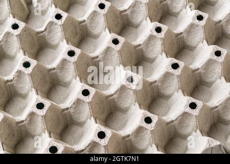 Empty egg tray texture. Background of large cardboard container for chicken eggs. Biodegradable paper packaging with repeating pattern for fragile egg Stock Photo