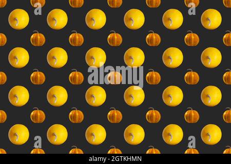 Pumpkins Seamless Pattern on Dark background, top view, Autumn Holiday Concept. Stock Photo