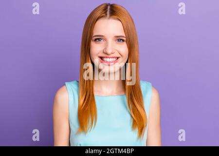 Portrait of attractive cheerful red-haired content girl wearing tank-top smiling isolated over purple violet color background Stock Photo