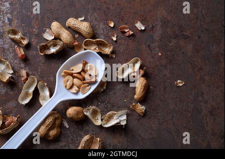 Peeled peanut on the rusty metal floor Stock Photo - Alamy