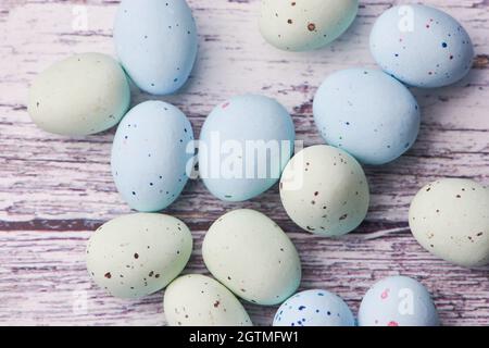 Yellow And Blue Dragee Eggs On A White Wooden Background, Macro Color Photo Stock Photo