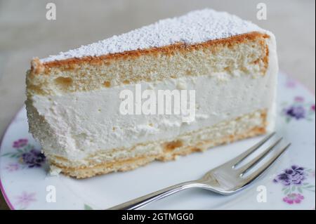 Close Up Of Cream-cheesecake On A Plate Beside Is Lying A Fork Stock Photo