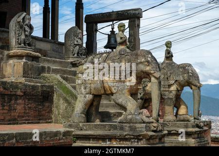 Stone elephants guard the entrance to the Uma Maheshwar temple in Kirtipur in the Kathmandu Valley, Nepal. Stock Photo