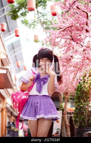 Portrait Of Young Wearing School Uniform Against Pink Cherry Blossoms