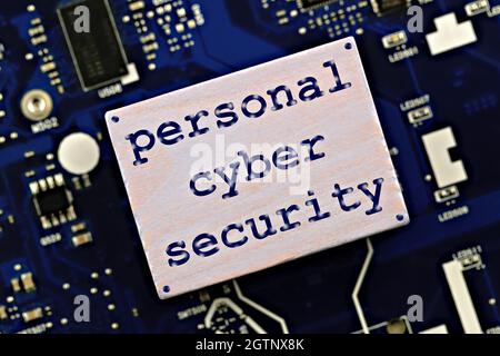 personal cybersecurity theme. the phrase personal cyber security, on the background of a computer microcircuit Stock Photo