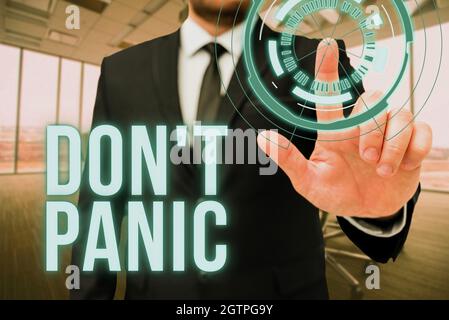 Hand writing sign Don T Panic. Word for suddenly feel so worried or frightened that you can not behave Man In Office Uniform Standing Pressing Virtual Stock Photo