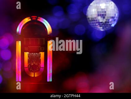Jukebox in Bar with Disco Ball and Bokeh Composite Image Stock Photo