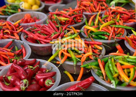Bowls of red and green chilli peppers for sale on market stall Birmingham Bullring Open Market Stock Photo