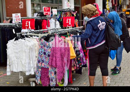 Shoppers looking for clothing at Birmingham Bullring Rag Market, UK Stock Photo