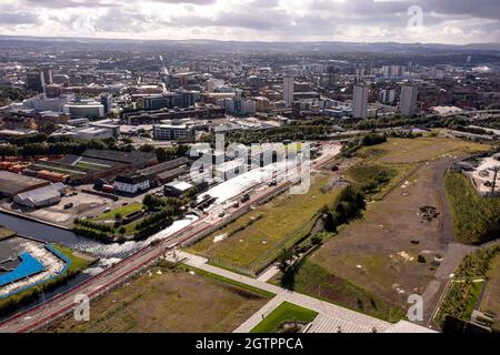 Glasgow, Scotland, UK. 29 September 2021 PICTURED:  Aerial drone view of Glasgow’s Sighthill area showing the new bridge over the M8 Motorway which joins the north of the city centre form the East going through to Charing Cross. The Sighthill area is seeing a capital investment of £250million with new recreational areas and social housing to the north of the city. Also in the area are white water rafting and kayaking training centres along with wakeboarding training facilities. Credit: Colin Fisher Stock Photo