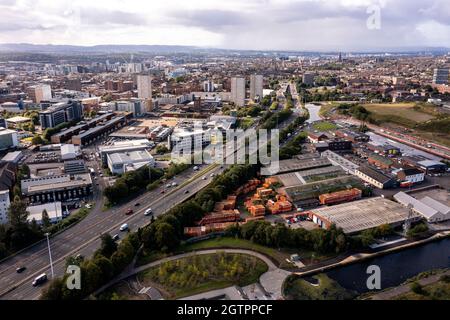 Glasgow, Scotland, UK. 29 September 2021 PICTURED:  Aerial drone view of Glasgow’s Sighthill area showing the new bridge over the M8 Motorway which joins the north of the city centre form the East going through to Charing Cross. The Sighthill area is seeing a capital investment of £250million with new recreational areas and social housing to the north of the city. Also in the area are white water rafting and kayaking training centres along with wakeboarding training facilities. Credit: Colin Fisher Stock Photo