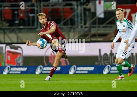 Nuremberg, Germany. 02nd Oct, 2021. Football: 2. Bundesliga, 1. FC Nürnberg - Hannover 96, Matchday 9, Max-Morlock-Stadion. Nuremberg's Asger Sörensen (l) plays a pass. Credit: Löb Daniel/dpa - IMPORTANT NOTE: In accordance with the regulations of the DFL Deutsche Fußball Liga and/or the DFB Deutscher Fußball-Bund, it is prohibited to use or have used photographs taken in the stadium and/or of the match in the form of sequence pictures and/or video-like photo series./dpa/Alamy Live News Stock Photo