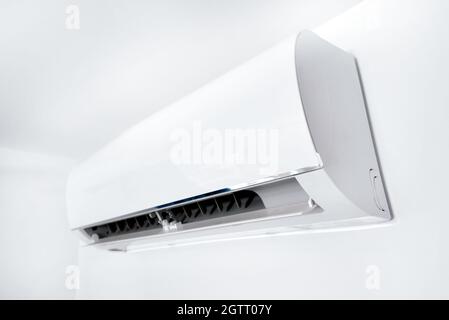 Air conditioner split hanging on the wall. Cooling device. Stock Photo
