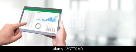Analyst works with the data. Graphs on the screen Stock Photo