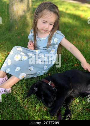 Girl On Field With Puppy