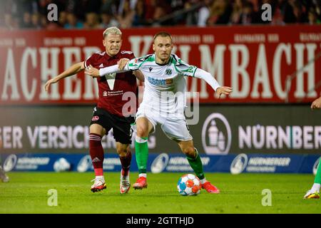 Nuremberg, Germany. 02nd Oct, 2021. Football: 2nd Bundesliga, 1. FC Nürnberg - Hannover 96, Matchday 9, Max Morlock Stadium. Hannover's Tom Trybull (r) shields Nuremberg's Lino Tempelmann (l) from the ball. Credit: Löb Daniel/dpa - IMPORTANT NOTE: In accordance with the regulations of the DFL Deutsche Fußball Liga and/or the DFB Deutscher Fußball-Bund, it is prohibited to use or have used photographs taken in the stadium and/or of the match in the form of sequence pictures and/or video-like photo series./dpa/Alamy Live News Stock Photo