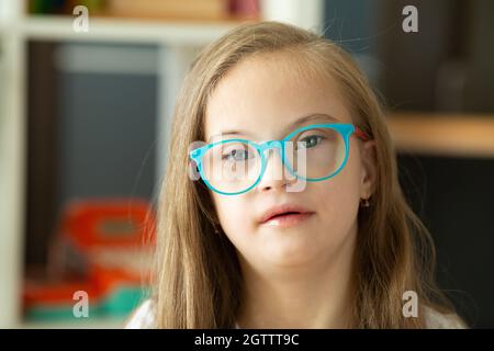 Beautiful portrait of a girl with Down syndrome at school Stock Photo