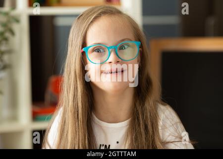 Beautiful portrait of a girl with Down syndrome at school Stock Photo