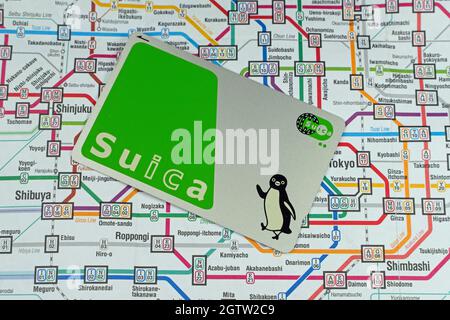 Suica IC Metro prepaid travel card on a train map of Tokyo. Stock Photo