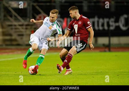 Nuremberg, Germany. 02nd Oct, 2021. Football: 2. Bundesliga, 1. FC Nürnberg - Hannover 96, Matchday 9, Max-Morlock-Stadion Hannover's Jannik Dehm (l) in action against Erik Shuranov from Nürnberg. Credit: Löb Daniel/dpa - IMPORTANT NOTE: In accordance with the regulations of the DFL Deutsche Fußball Liga and/or the DFB Deutscher Fußball-Bund, it is prohibited to use or have used photographs taken in the stadium and/or of the match in the form of sequence pictures and/or video-like photo series./dpa/Alamy Live News Stock Photo