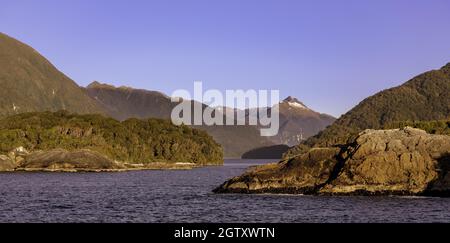 Scenic View Of Sea And Mountains Against Clear Blue Sky