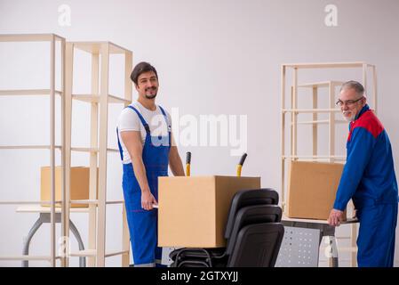 Two professional movers doing home relocation Stock Photo