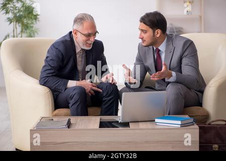 Two businessmen discussing project in the office Stock Photo