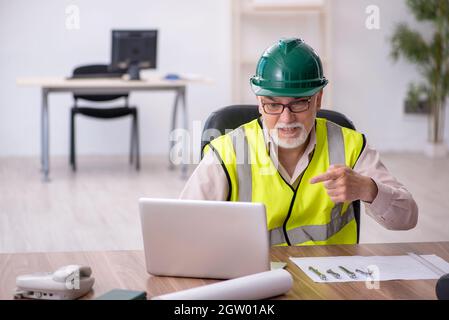 Old architect working in the office Stock Photo