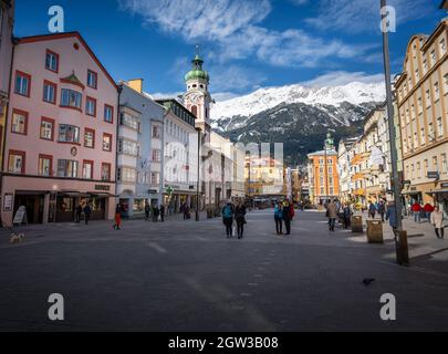 Street view of Maria-Theresien-Strasse with Alps Mountains on background - Innsbruck, Tyrol, Austria Stock Photo