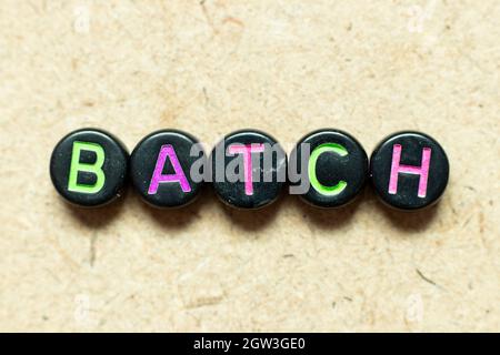 Black color round alphabet letter block in word batch on wood background Stock Photo