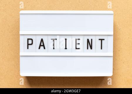 Lightbox with word patient on wood background Stock Photo