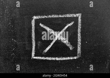 White color chalk hand drawing in cross check makr in square box shape on black board background Stock Photo