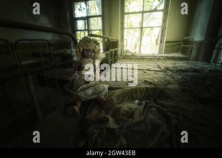 Abandoned doll at Kindergarten  - Kopachi Village, Chernobyl Exclusion Zone, Ukraine Stock Photo