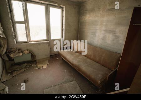 Living room and sofa at an apartment in Pripyat - Pripyat, Chernobyl Exclusion Zone, Ukraine Stock Photo