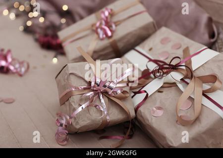 Christmas gifts on the bed among the pillows, Christmas gift wrapping concept. Stock Photo
