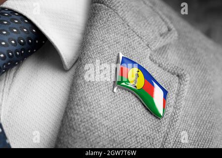 Metal badge with the flag of New Caledonia on a suit lapel Stock Photo